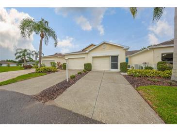 Charming home featuring a two-car garage, well-manicured landscaping, and a welcoming entrance at 1012 Radison Lake Ct # 59, Sun City Center, FL 33573