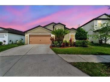 Charming single-Gathering home with lush landscaping and a two-car garage at 11837 Thicket Wood Dr, Riverview, FL 33579