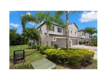 Attractive two-story home featuring manicured landscaping, multi-car garage, and neutral paint at 1395 White Fox Run, Lutz, FL 33549