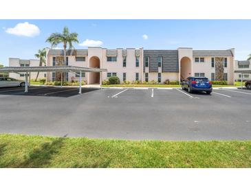 Well-maintained condo building with covered parking and mature landscaping at 213 Fernwood Cir # 213, Seminole, FL 33777