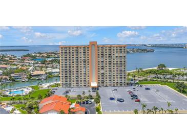 High-rise condo building showcases amazing water views, a parking lot, and lush landscaping at 4900 Brittany S Dr # 611, St Petersburg, FL 33715