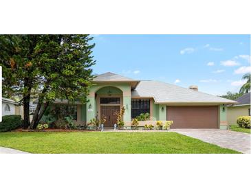 Charming single-story home with a well-maintained lawn, lush landscaping, and a two-car garage at 6621 Appaloosa Dr, Tampa, FL 33625