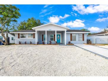 Charming single-story home with a bright blue front door and newly landscaped gravel front yard at 7804 Bracken Dr, Port Richey, FL 34668
