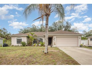 Charming single-story home featuring a two-car garage and well-maintained landscaping in a quiet neighborhood at 2816 Soprano Ln, North Port, FL 34286