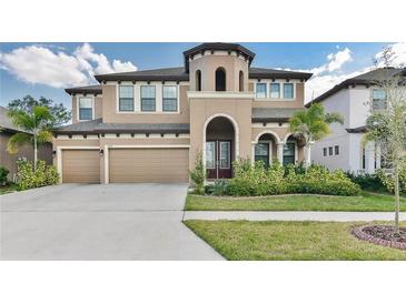 Beautiful two-story home with a two-car garage and well-maintained landscaping at 11407 Drifting Leaf Dr, Riverview, FL 33579