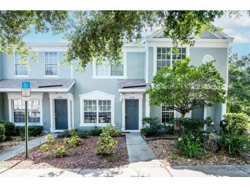 Inviting townhome showcasing a well-maintained facade and lovely landscaped front yard at 2316 Lake Woodberry Cir, Brandon, FL 33510