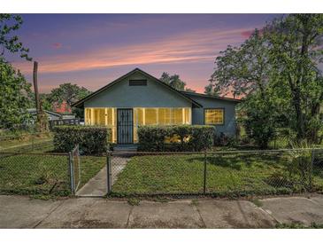 Charming bungalow featuring a cozy enclosed porch and well-maintained front yard at 3008 E Wilder Ave, Tampa, FL 33610