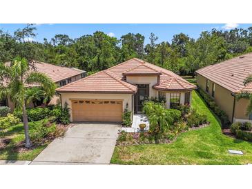 Charming single-story home with a tile roof, well-maintained landscaping, and attached garage at 137 Silver Falls Dr, Apollo Beach, FL 33572