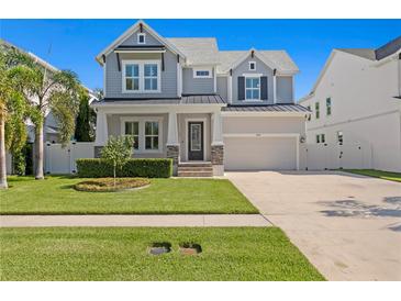 Charming two-story home features a manicured lawn and covered front porch, enhancing its curb appeal at 3605 W Dale Ave, Tampa, FL 33609