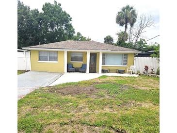 Charming single-story home with a well-maintained lawn and inviting front porch seating at 4111 W La Salle St, Tampa, FL 33607