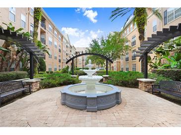 Beautiful water fountain within a community courtyard with seating, landscaping, and architecture with blue sky above at 4221 W Spruce St # 1429, Tampa, FL 33607