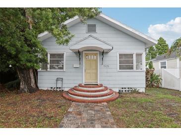 Charming single-story home with a welcoming brick walkway and light-blue painted siding at 1525 38Th N Ave, St Petersburg, FL 33704