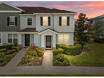 Charming two-story townhome with well-maintained landscaping and a welcoming front entrance at 15430 Caravan Ave, Odessa, FL 33556