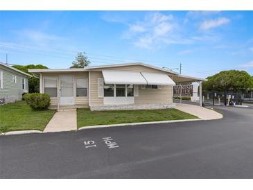 Charming single-story home featuring a covered carport and well-maintained landscaping at 7118 El Meyers St, Zephyrhills, FL 33541