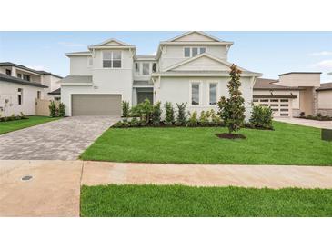 Charming two-story home with a well-manicured lawn and a brick driveway leading to a two-car garage at 8316 Golden Beach Ct, Parrish, FL 34219