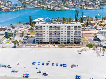 Beautiful beachfront condo building with a pool, beach access, and lovely balconies at 13500 Gulf Blvd # 507, Madeira Beach, FL 33708