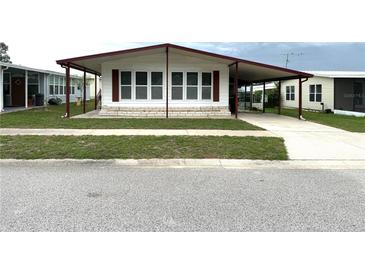 Charming single-story home with covered parking and well-maintained front lawn at 3910 Sarah Dr, Wesley Chapel, FL 33543
