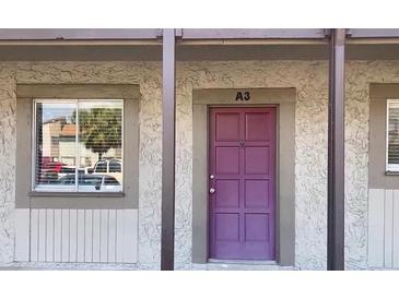 A ground floor condominium entrance with a purple door, a window, and the unit number marked above the door at 6306 Newtown Cir # 6A3, Tampa, FL 33615