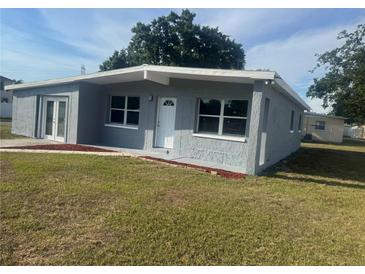 Charming gray home with white trim, well-kept lawn, and inviting front entrance at 8502 Grapefruit Ave, Tampa, FL 33619
