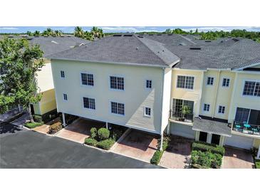 Charming townhome with carports and well-maintained landscaping, showcasing its inviting curb appeal at 9731 Meadow Field Cir, Tampa, FL 33626