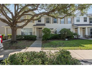 Charming two-story townhouse featuring manicured landscaping and inviting front entrance at 13521 Forest Lake Dr, Largo, FL 33771