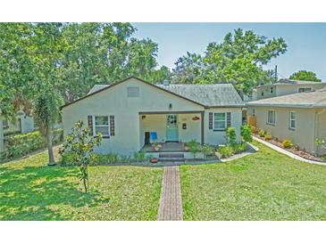 Charming single-story home with a well-manicured lawn and inviting blue door at 1620 15Th N St, St Petersburg, FL 33704