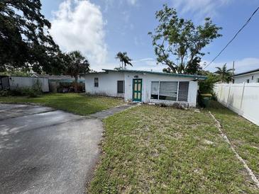 Charming single-story home with a unique teal door, awaiting your personal touch at 2524 Novus St, Sarasota, FL 34237