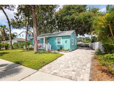 Charming bungalow featuring a well manicured lawn, brick driveway and quaint front porch at 2709 Upton S St, Gulfport, FL 33711