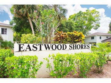 Eastwood Shores sign surrounded by colorful shrubbery, establishing the community's name and location at 2943 Bough Ave # C, Clearwater, FL 33760