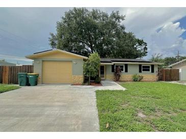 Charming single-story home with a welcoming facade and attached garage on a sunny day at 3619 15Th Se Ave, Largo, FL 33771