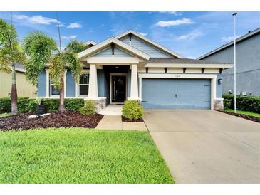 Charming single-Gathering home with well-manicured lawn and tropical landscaping at 6127 Colmar Pl, Apollo Beach, FL 33572