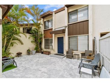 Charming two-story townhome with a beautiful brick patio surrounded by tropical landscaping at 1881 N Hercules Ave # 602, Clearwater, FL 33765