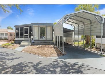 Charming single-story home featuring a covered carport and a cozy screened-in porch at 4851 W Gandy Blvd # B1L8, Tampa, FL 33611