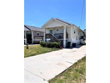 Inviting single-story home featuring a spacious front porch and a well-manicured lawn, perfect for relaxation at 5351 Leisure Ln, New Port Richey, FL 34652