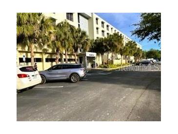 Attractive building with palm trees providing shade for parked cars and pedestrians at 701 S Madison Ave # 515, Clearwater, FL 33756