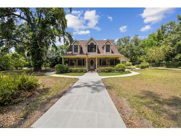 Charming two-story home with a welcoming front porch and well-manicured landscaping, showcasing curb appeal at 3018 Pemberton Trace Ct, Plant City, FL 33565