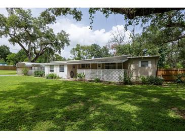Charming single-story home features a large, grassy yard and a covered carport at 7240 Ottley St, Zephyrhills, FL 33541