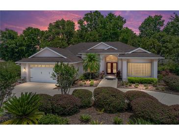 Charming single-story home with a landscaped front yard, curved walkway, double front doors and attached two-car garage at 11530 Arlhuna Way, Dade City, FL 33525