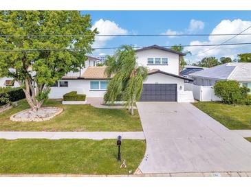 Beautiful two-story home featuring a well-maintained lawn and a spacious two-car garage at 234 Palm Sw Is, Clearwater Beach, FL 33767