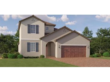 Charming two-story home with a welcoming facade and a two-car garage at 31890 Griffin Sands Ln, San Antonio, FL 33576