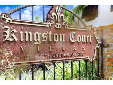 Elegant Kingston Court Villas community sign with a fleur-de-lis design against a wrought iron fence at 120 S Church Ave # 202, Tampa, FL 33609