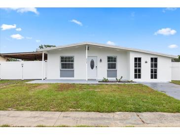 Charming single-story home showcasing a well-maintained lawn and inviting entrance at 2408 Wishing Well Way, Tampa, FL 33619