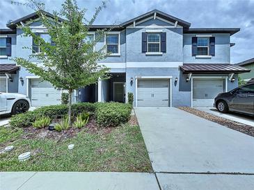 Charming two-story townhouse with a well-manicured lawn and a private garage at 30729 Veridian Way, Wesley Chapel, FL 33543
