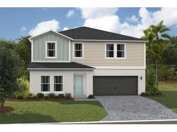 Inviting two-story home featuring a two-car garage, neutral color palette, and lush landscaping at 37009 Sagemoor Dr, Zephyrhills, FL 33541
