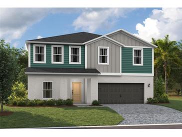 Charming two-story home with a two-car garage, a welcoming front lawn and a quaint front door at 37029 Sagemoor Dr, Zephyrhills, FL 33541
