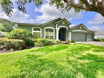 Charming single-story home with a manicured lawn and attached two-car garage at 4418 Gentrice Dr, Valrico, FL 33596