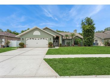 Charming single-story home with a well-manicured lawn, mature landscaping, and a two-car garage at 8549 Pinafore Dr, New Port Richey, FL 34653