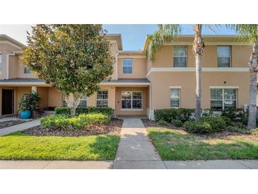 Inviting townhome featuring neat landscaping and a well-maintained exterior at 9752 Trumpet Vine Loop, Trinity, FL 34655