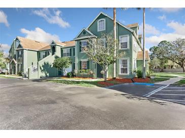 Attractive condo building featuring well-maintained landscaping and convenient parking at 10412 White Lake Ct, Tampa, FL 33626