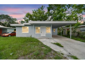 Charming single-story home featuring a covered carport and a well-maintained front yard at 1807 E Bougainvillea Ave, Tampa, FL 33612